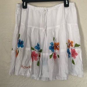 White Hawaiian skirt with floral accents.